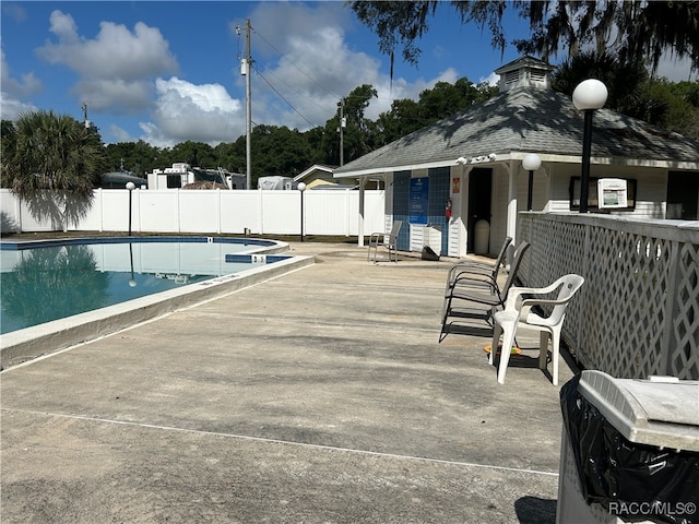 view of swimming pool featuring a patio area