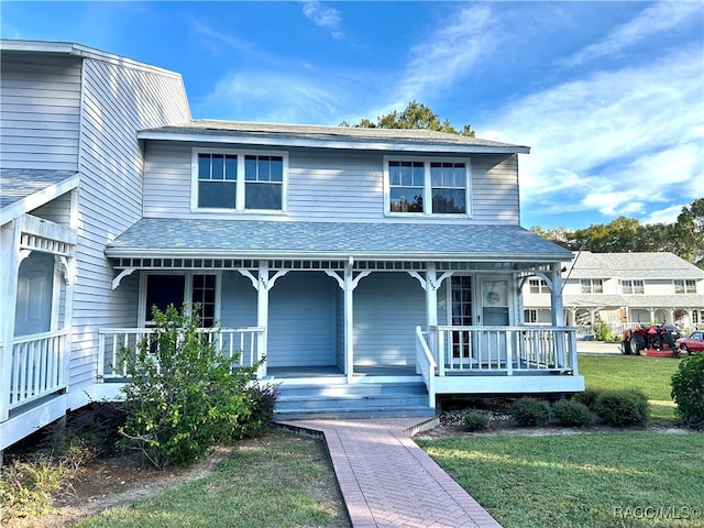 view of front facade featuring a front lawn and covered porch