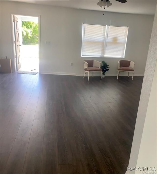 empty room featuring ceiling fan and dark hardwood / wood-style floors