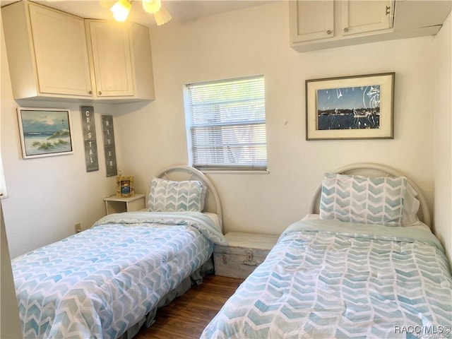 bedroom with ceiling fan and dark hardwood / wood-style floors