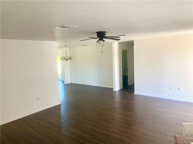 unfurnished room with dark wood-type flooring and ceiling fan with notable chandelier