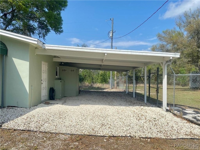 view of parking / parking lot featuring a carport