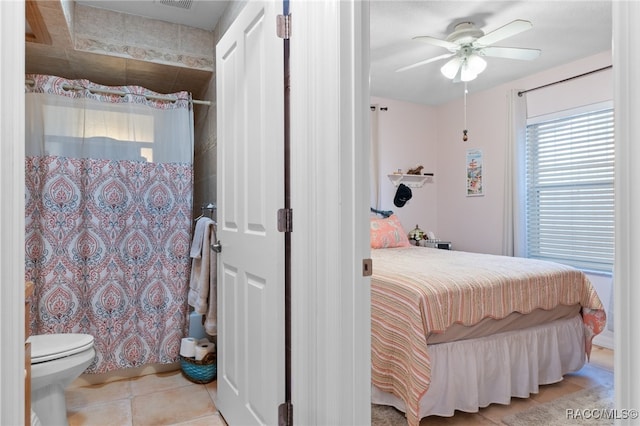 bedroom featuring light tile patterned floors, ceiling fan, and visible vents