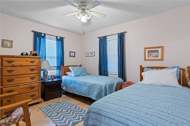 bedroom featuring light tile patterned flooring and a ceiling fan