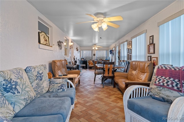 living room featuring ceiling fan and brick floor