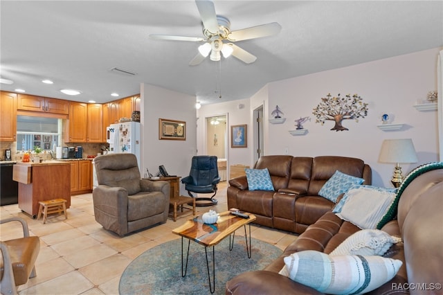 living room with a ceiling fan, light tile patterned flooring, and visible vents