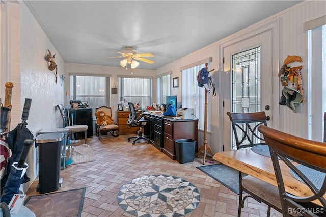 home office featuring brick floor and a ceiling fan