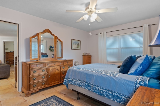 bedroom with light tile patterned flooring and a ceiling fan