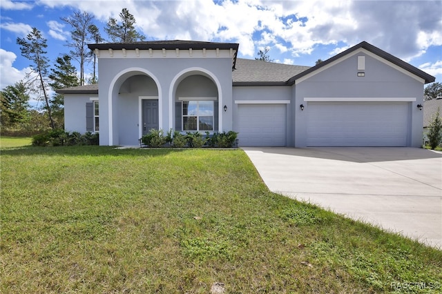 view of front facade with a garage and a front lawn