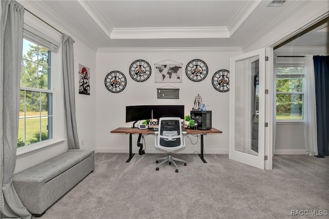 carpeted home office featuring a raised ceiling, french doors, and ornamental molding