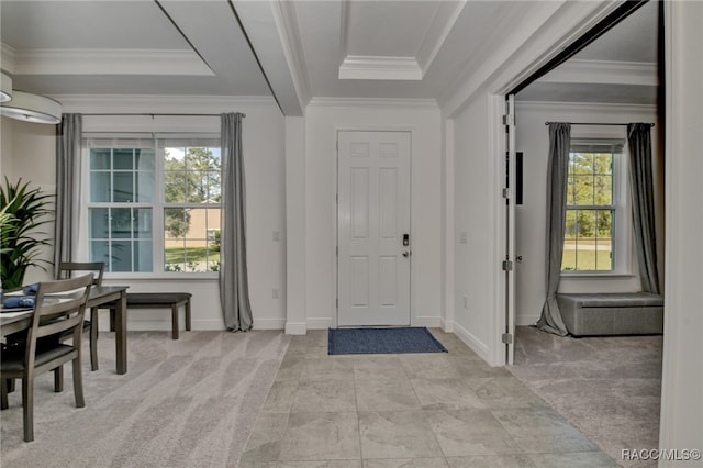 foyer entrance with light carpet and crown molding