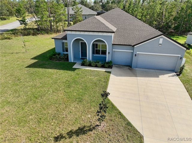 view of front of house with a front yard and a garage