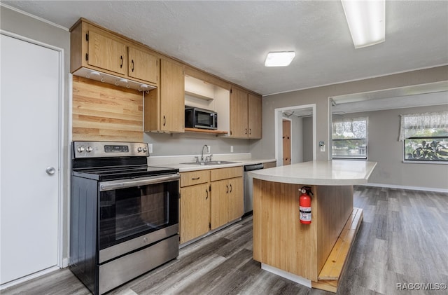 kitchen featuring light brown cabinets, sink, a kitchen island, dark hardwood / wood-style flooring, and stainless steel appliances