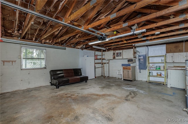 garage with a garage door opener and electric panel