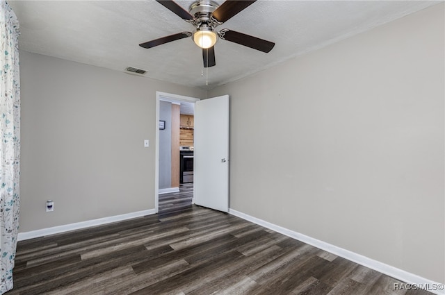 unfurnished room featuring ceiling fan, dark hardwood / wood-style flooring, and a textured ceiling