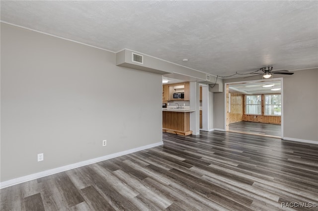 unfurnished living room with a textured ceiling, dark hardwood / wood-style flooring, and ceiling fan