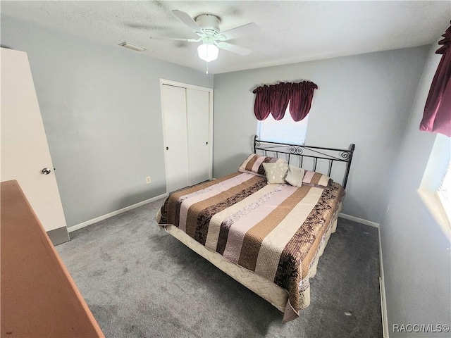 carpeted bedroom with a closet, visible vents, a ceiling fan, and baseboards