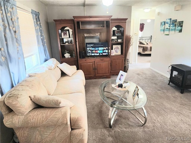 living room featuring light colored carpet and baseboards