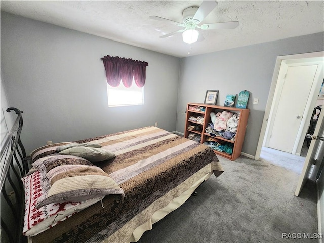 carpeted bedroom with baseboards, a textured ceiling, and a ceiling fan