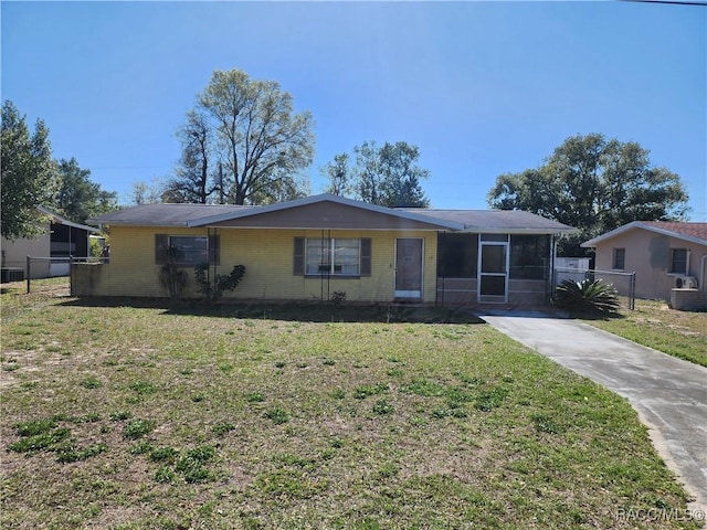 ranch-style home featuring a front yard and fence