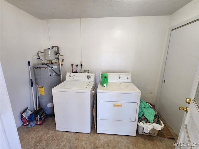 washroom featuring laundry area, washer and dryer, and electric water heater