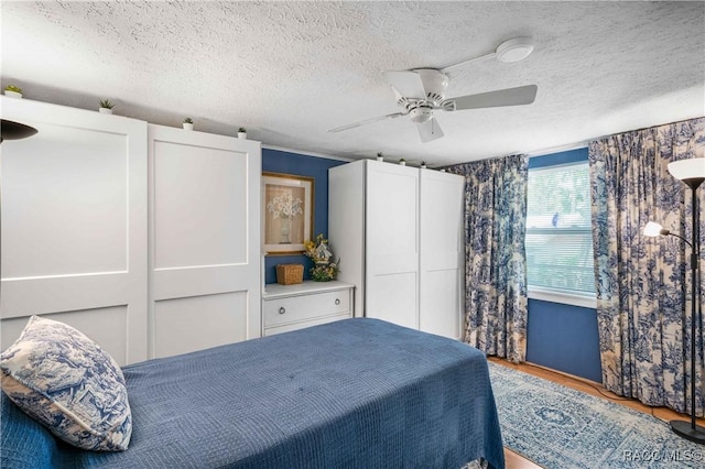 13465 W Hillbilly Ln, Crystal River, FL 34429 - bedroom with wood finished floors, a textured ceiling, and ceiling fan