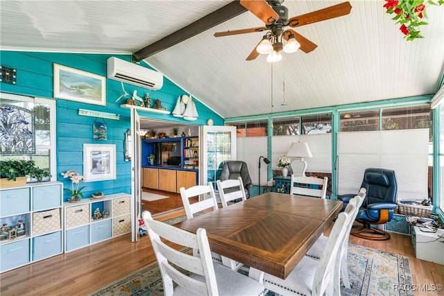 13465 W Hillbilly Ln, Crystal River, FL 34429 - dining space with a wall unit AC, wood finished floors, ceiling fan, and healthy amount of natural light