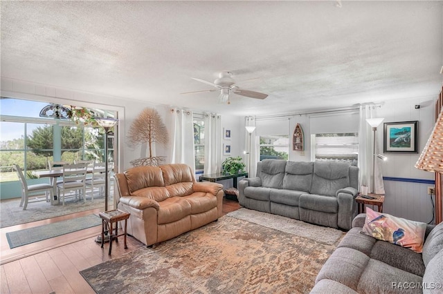 13465 W Hillbilly Ln, Crystal River, FL 34429 - living room featuring a ceiling fan, hardwood / wood-style floors, and a textured ceiling