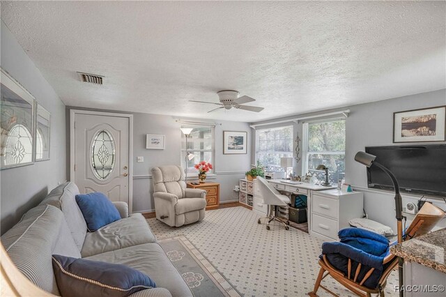 13465 W Hillbilly Ln, Crystal River, FL 34429 - office area featuring a ceiling fan, a textured ceiling, and light carpet