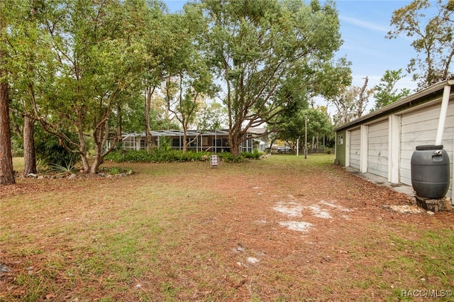 view of yard featuring glass enclosure