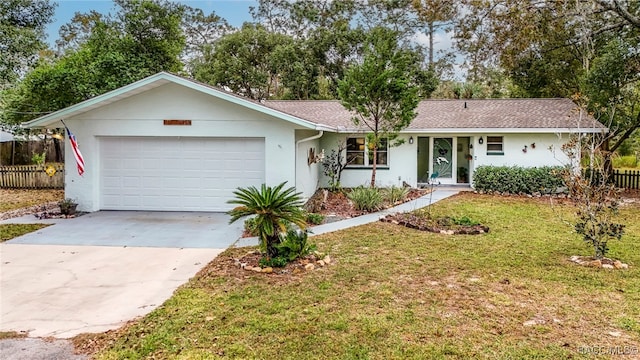 single story home featuring a front yard and a garage