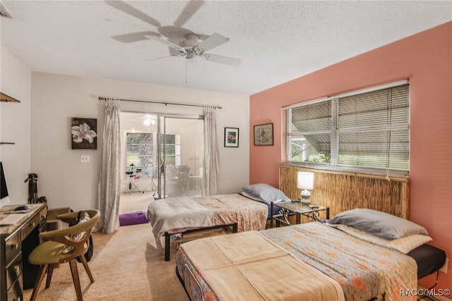 carpeted bedroom with access to exterior, ceiling fan, and a textured ceiling