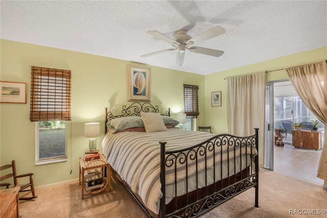 bedroom with a textured ceiling, ceiling fan, and light carpet