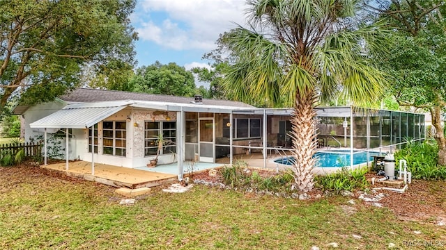 rear view of house featuring a lawn, a fenced in pool, and a patio