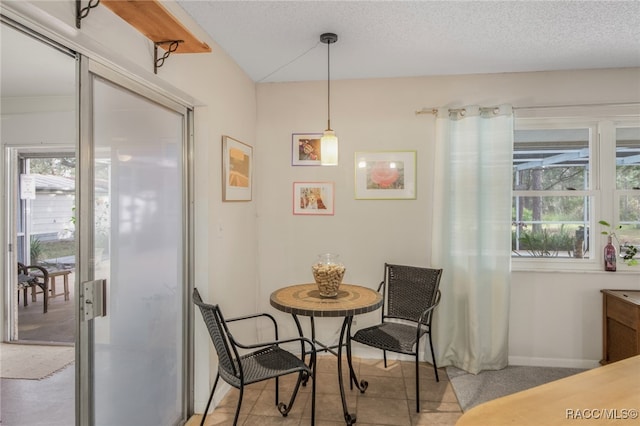 dining area featuring a textured ceiling