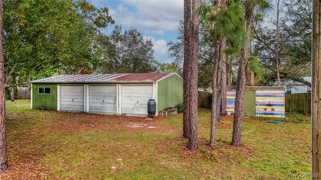 exterior space featuring a garage and a lawn