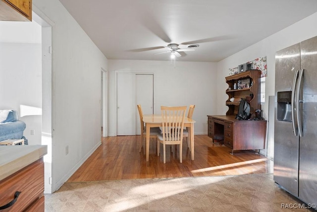 dining room featuring light wood-type flooring, ceiling fan, and baseboards