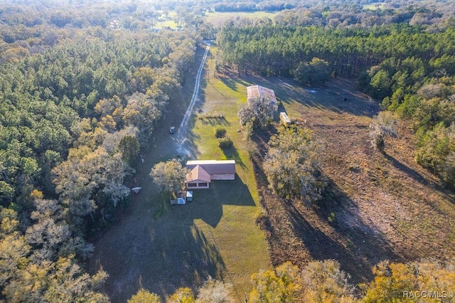 aerial view featuring a wooded view and a rural view