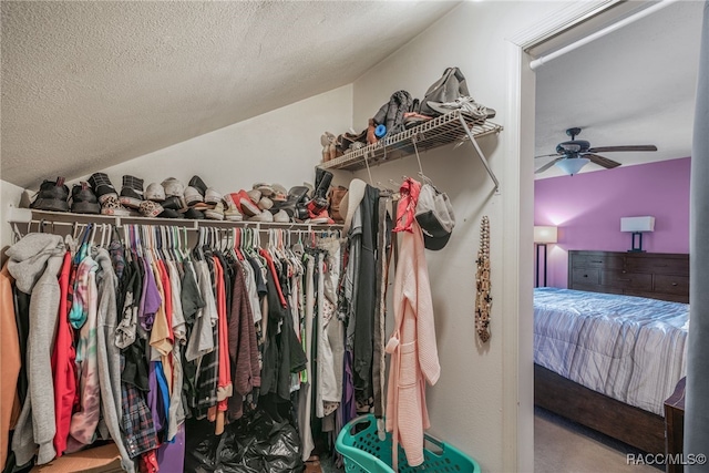 walk in closet featuring a ceiling fan