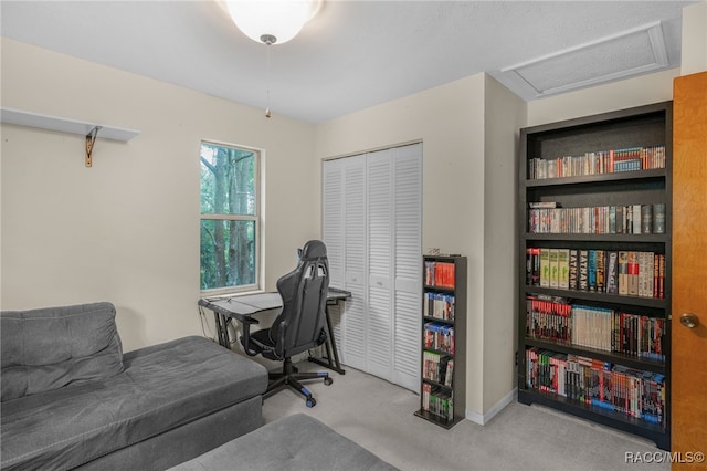 carpeted office space with attic access