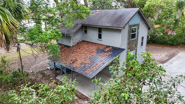 exterior space with roof with shingles