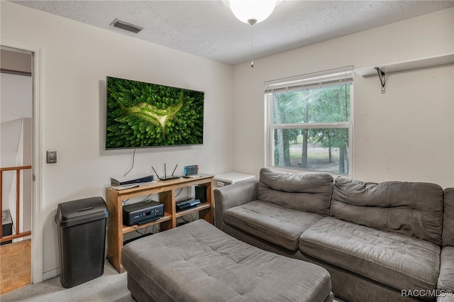 living room featuring visible vents and a textured ceiling