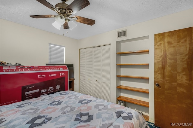 bedroom with visible vents, a ceiling fan, and a textured ceiling