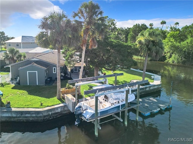 dock area featuring a water view and a lawn