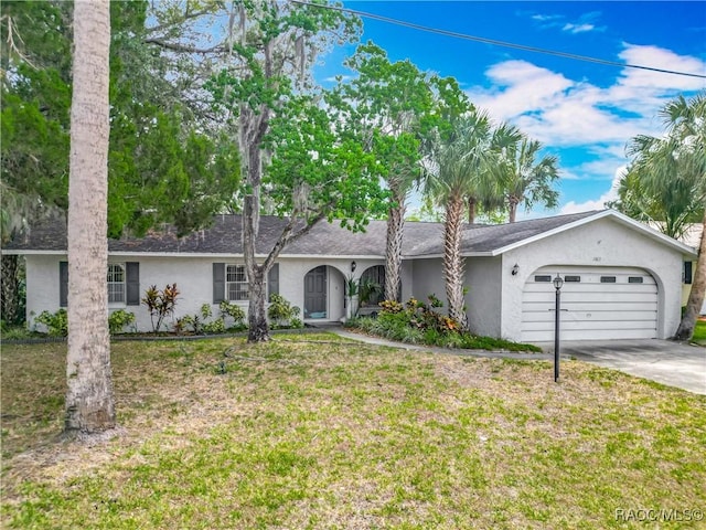 single story home with concrete driveway, an attached garage, a front lawn, and stucco siding