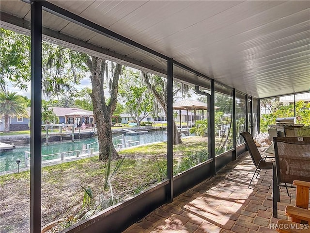 sunroom / solarium with a water view