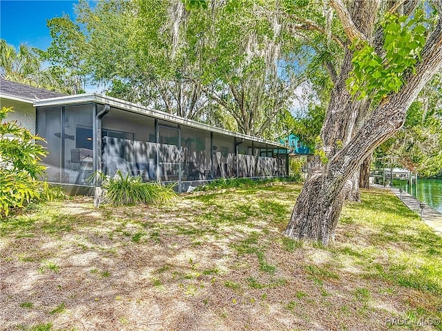 rear view of property featuring a sunroom