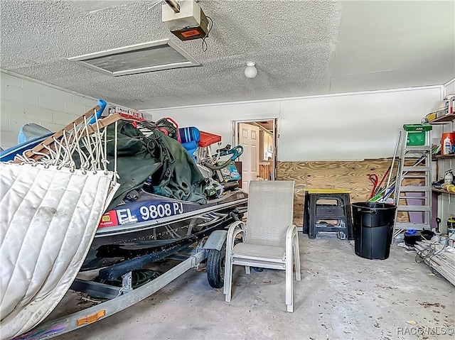 garage with concrete block wall and a garage door opener