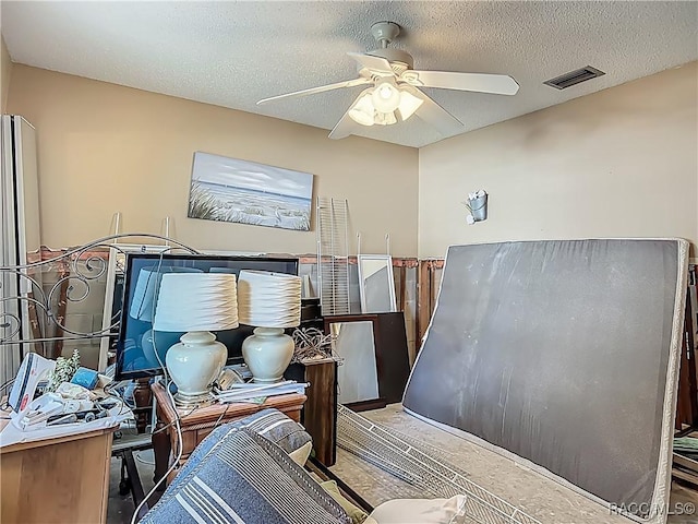office area with a textured ceiling, ceiling fan, and visible vents