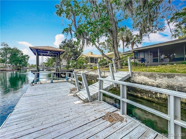 dock area featuring a water view and boat lift